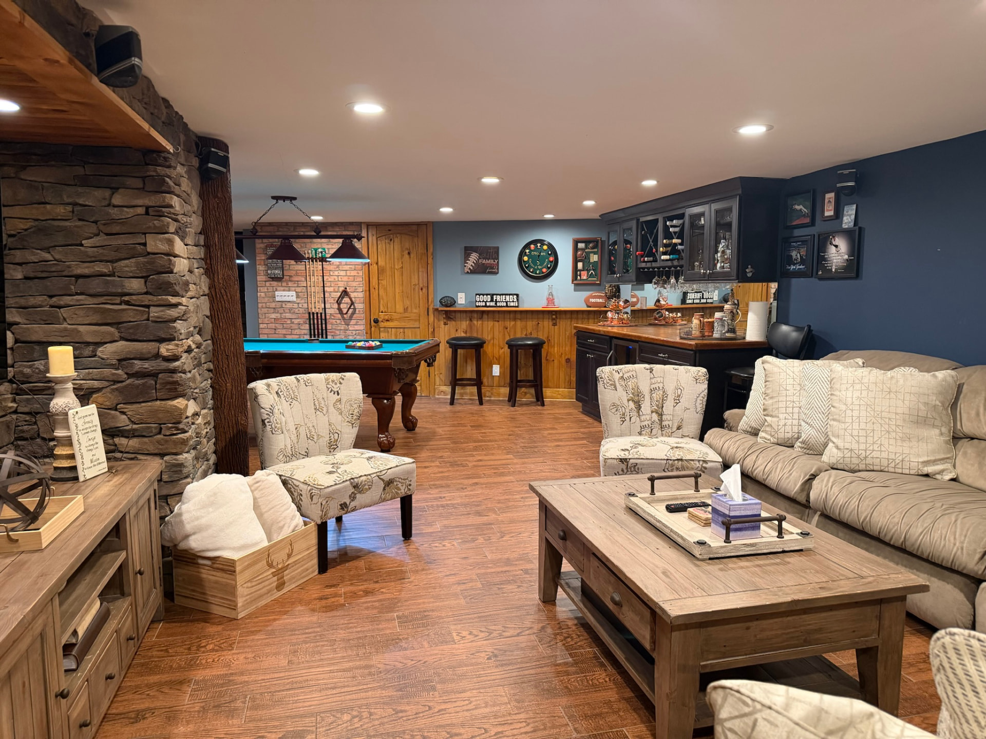 Finished basement with stone wall, wet bar, and billiards area