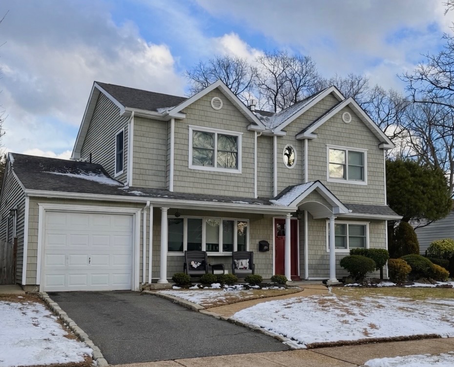 Completed shed dormer and front portico on a Long Island home