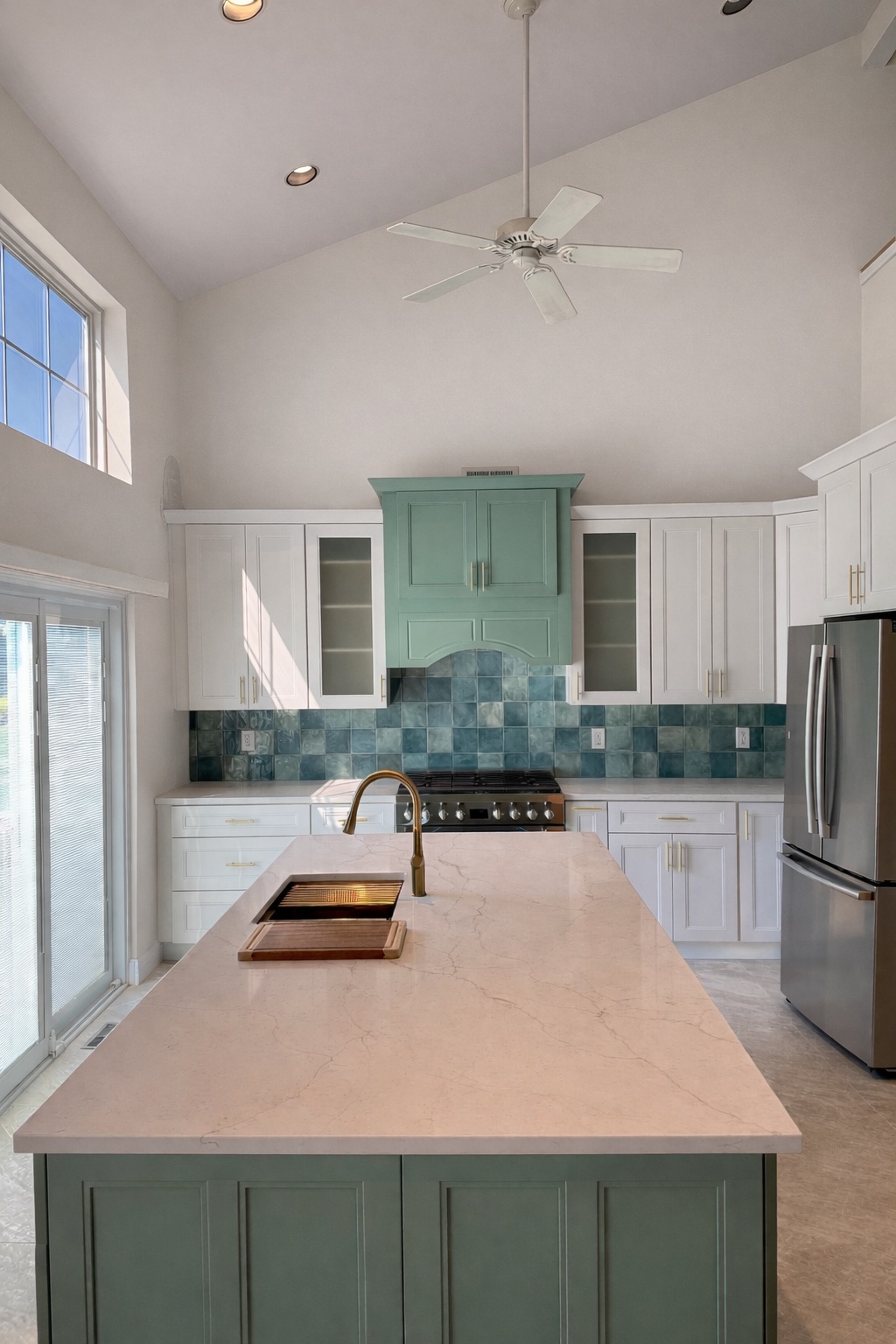 Vaulted-ceiling kitchen with green island and blue tile backsplash