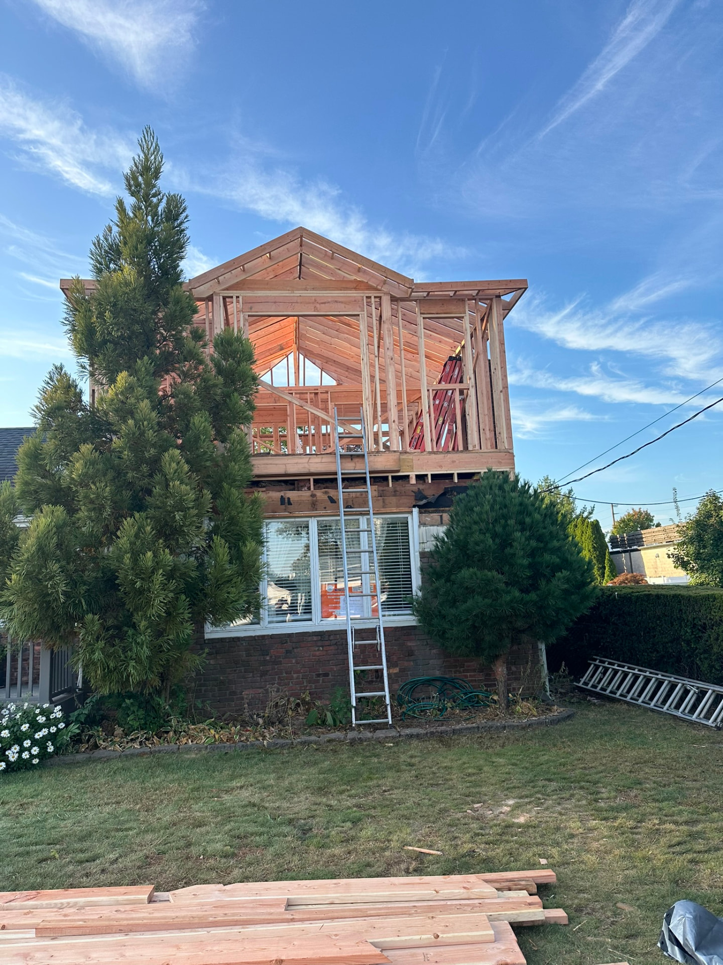 New dormer framed above a brick Long Island home