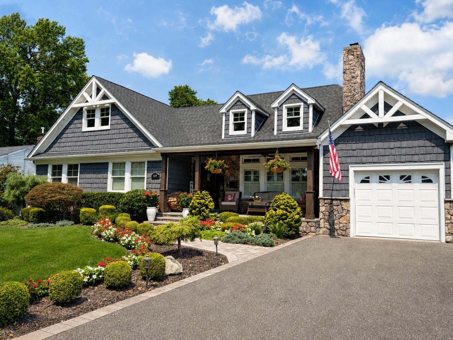 Craftsman-style remodel with dormers, dark shake siding, and stonework