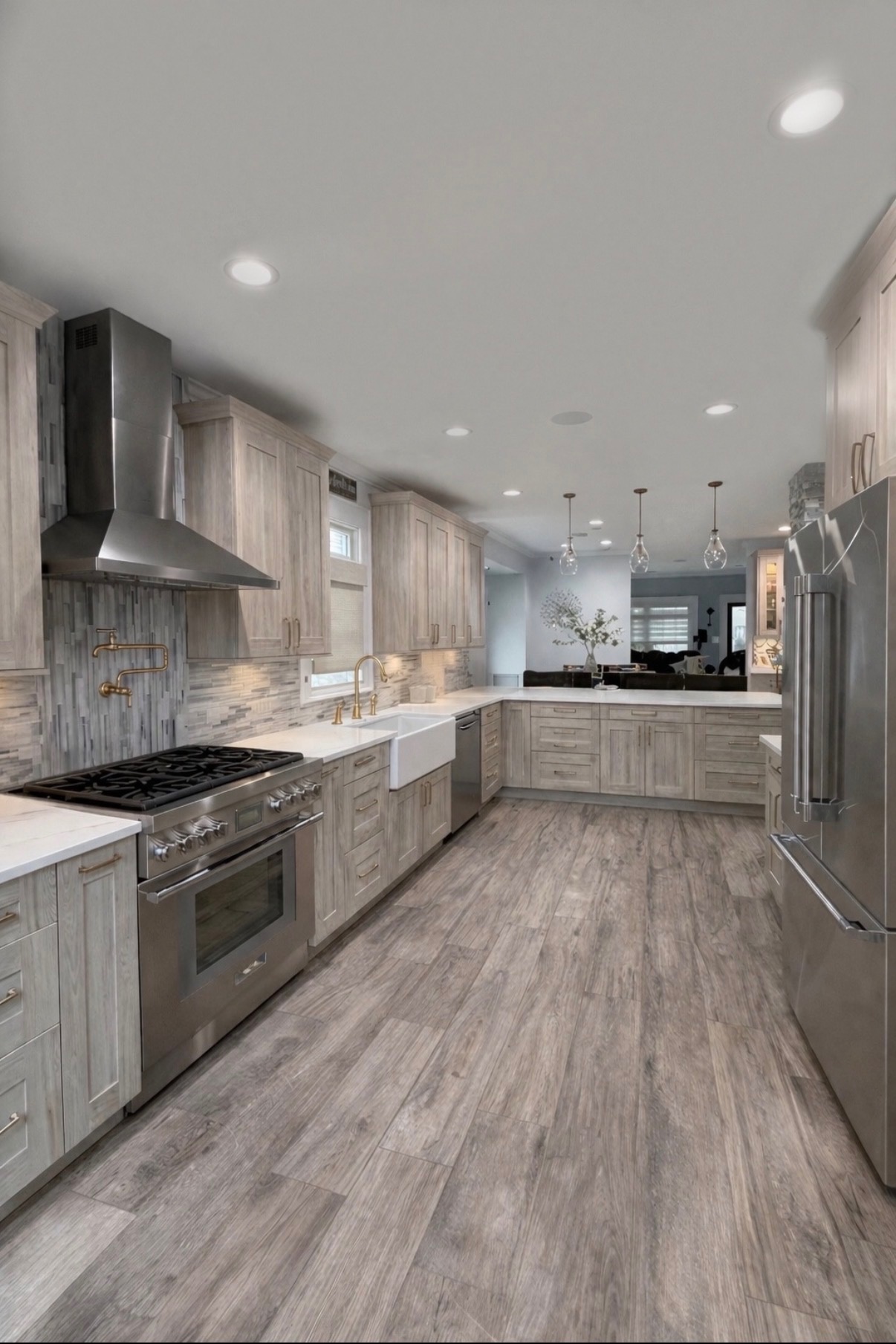 Open kitchen with weathered gray cabinetry and farmhouse sink
