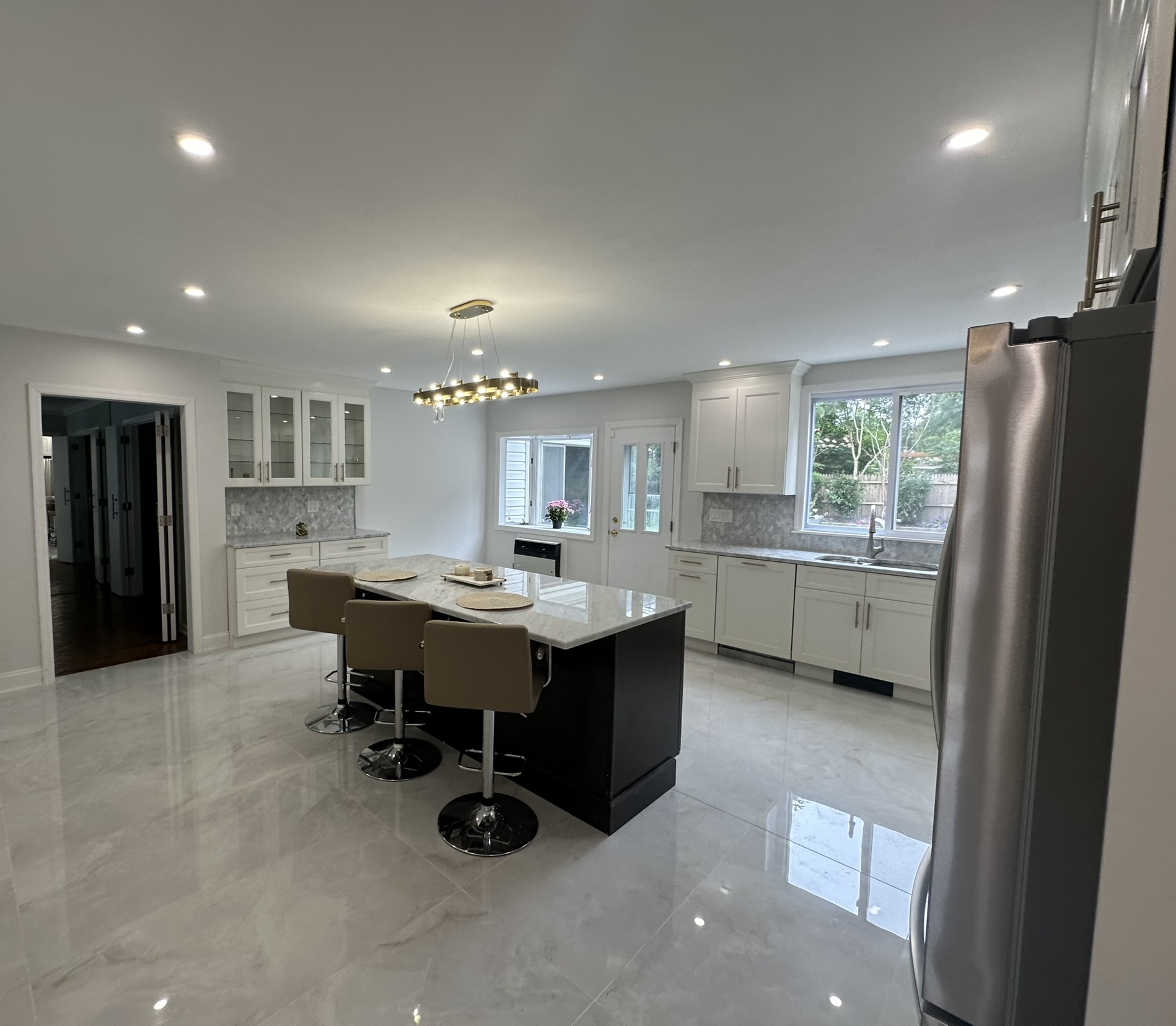 Kitchen remodel with marble floors and dark center island